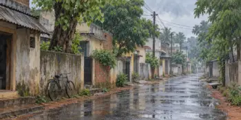 A wet monsoon street with reflections and a parked bicycle