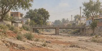 A dry riverbed with a narrow footbridge